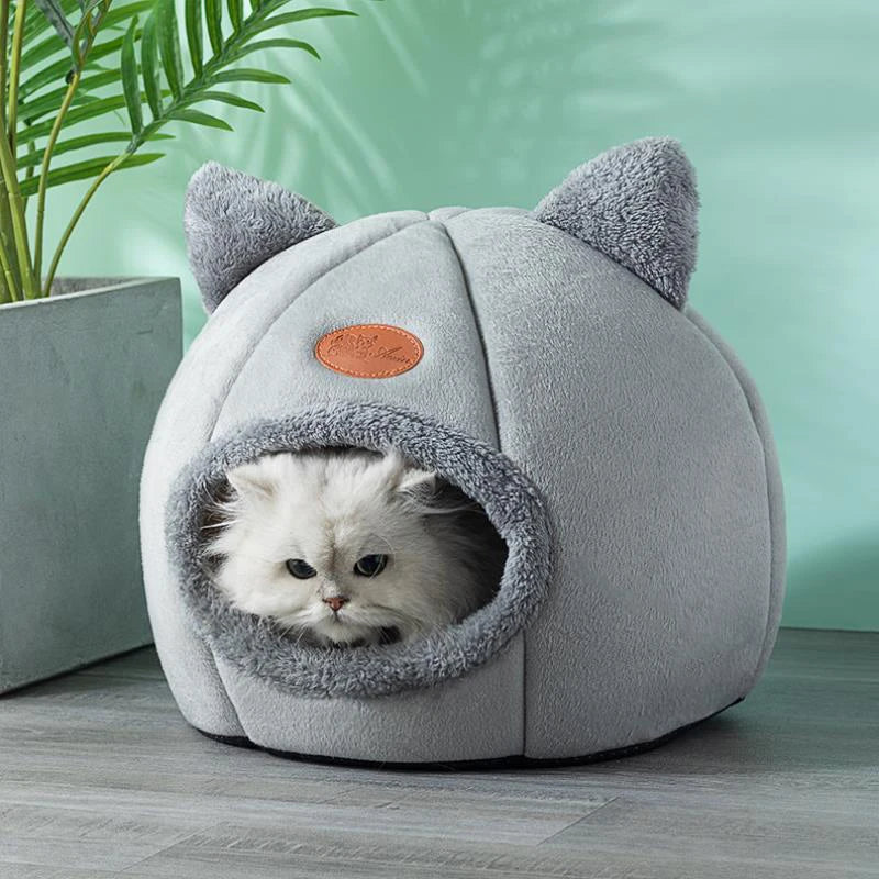 Cat resting in a cosy cave bed – photo 3