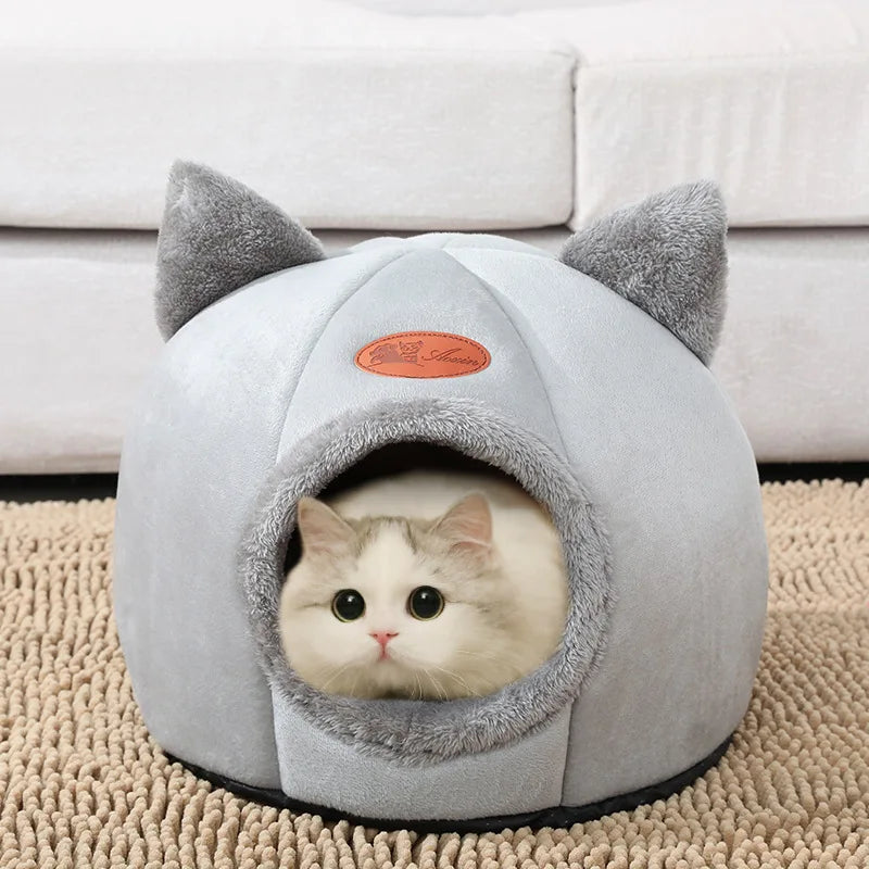 Cat resting in a cosy cave bed – photo 2