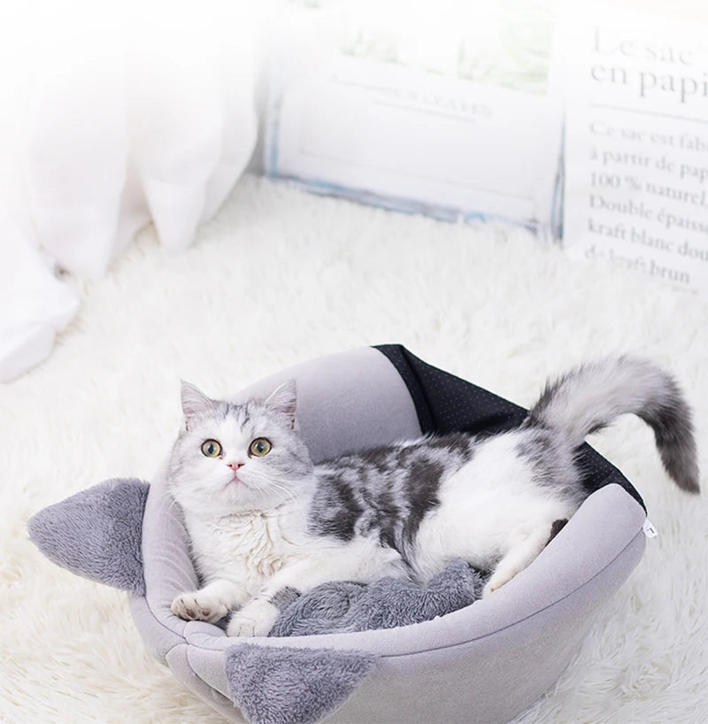 Cat resting in a cosy cave bed – photo 11
