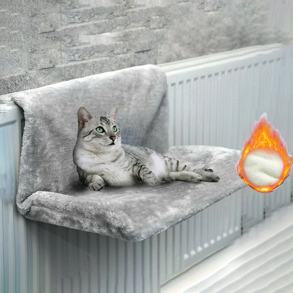 Cat relaxing in a plush hanging radiator bed