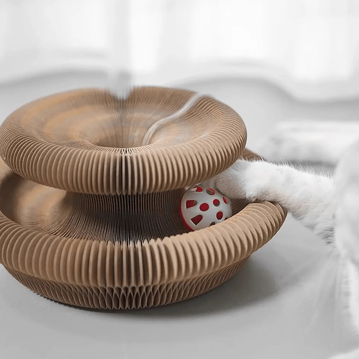 Twisting corrugated cardboard cat scratcher toy with bell ball