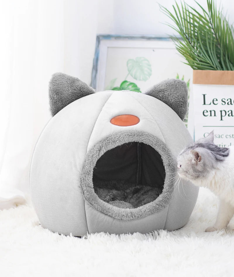 Cat resting in a cosy cave bed – photo 10